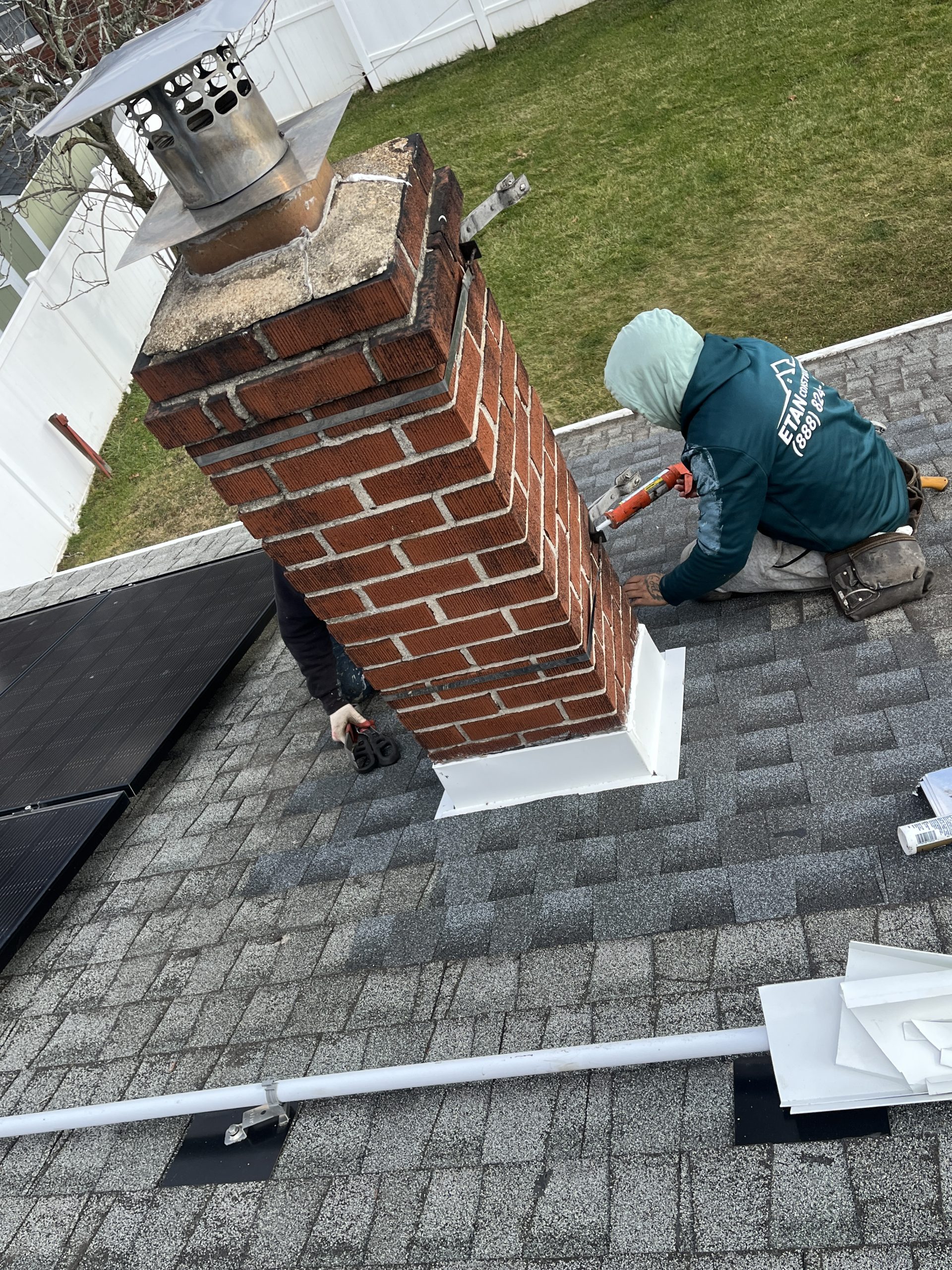 Professional from doda brother working on a chimney in a roof. 