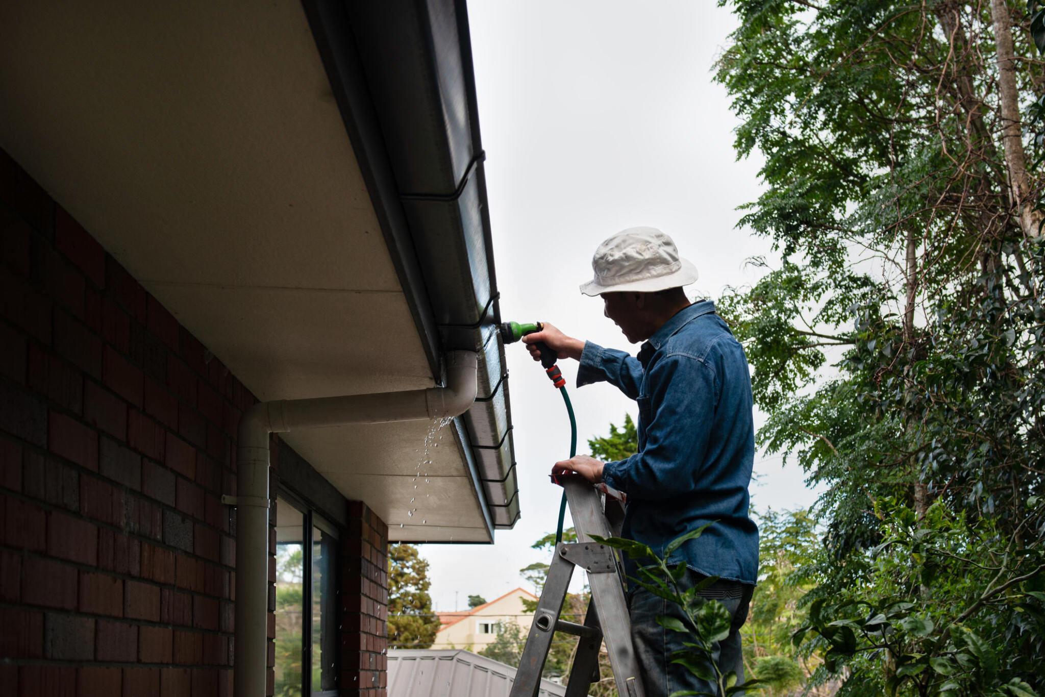Professional doing gutter services in New Jersey. 